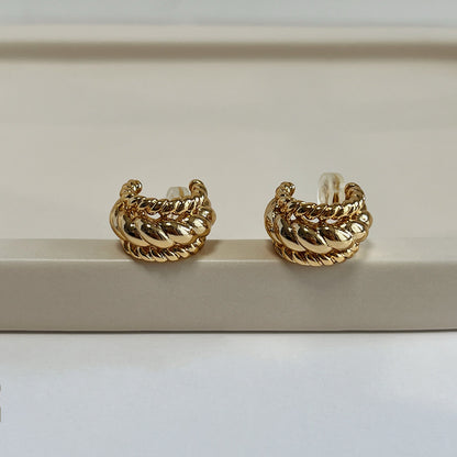 Waterproof gold clip-on earrings with a secure, invisible-fit mechanism.