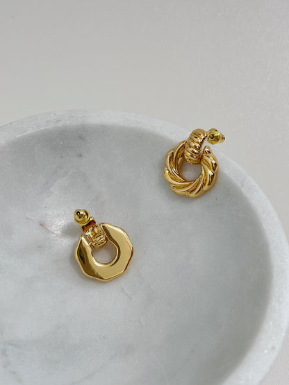 Classy 18k gold plated mini knot earrings, ideal for a polished and refined style, showcasing on a marble bowl