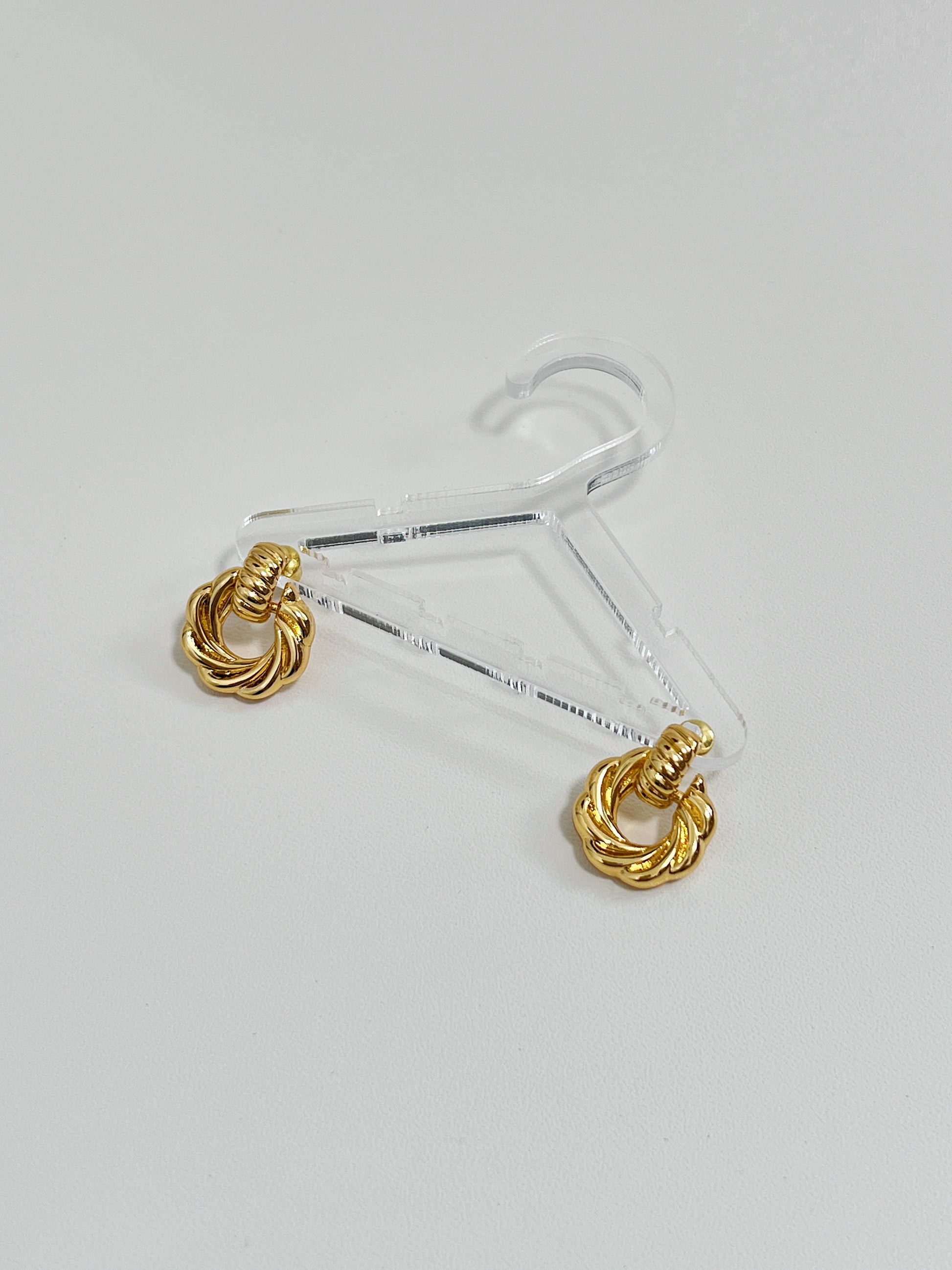 Gold mini knot earrings made of 18k gold plated brass, versatile and timeless accessory, front of the earrings