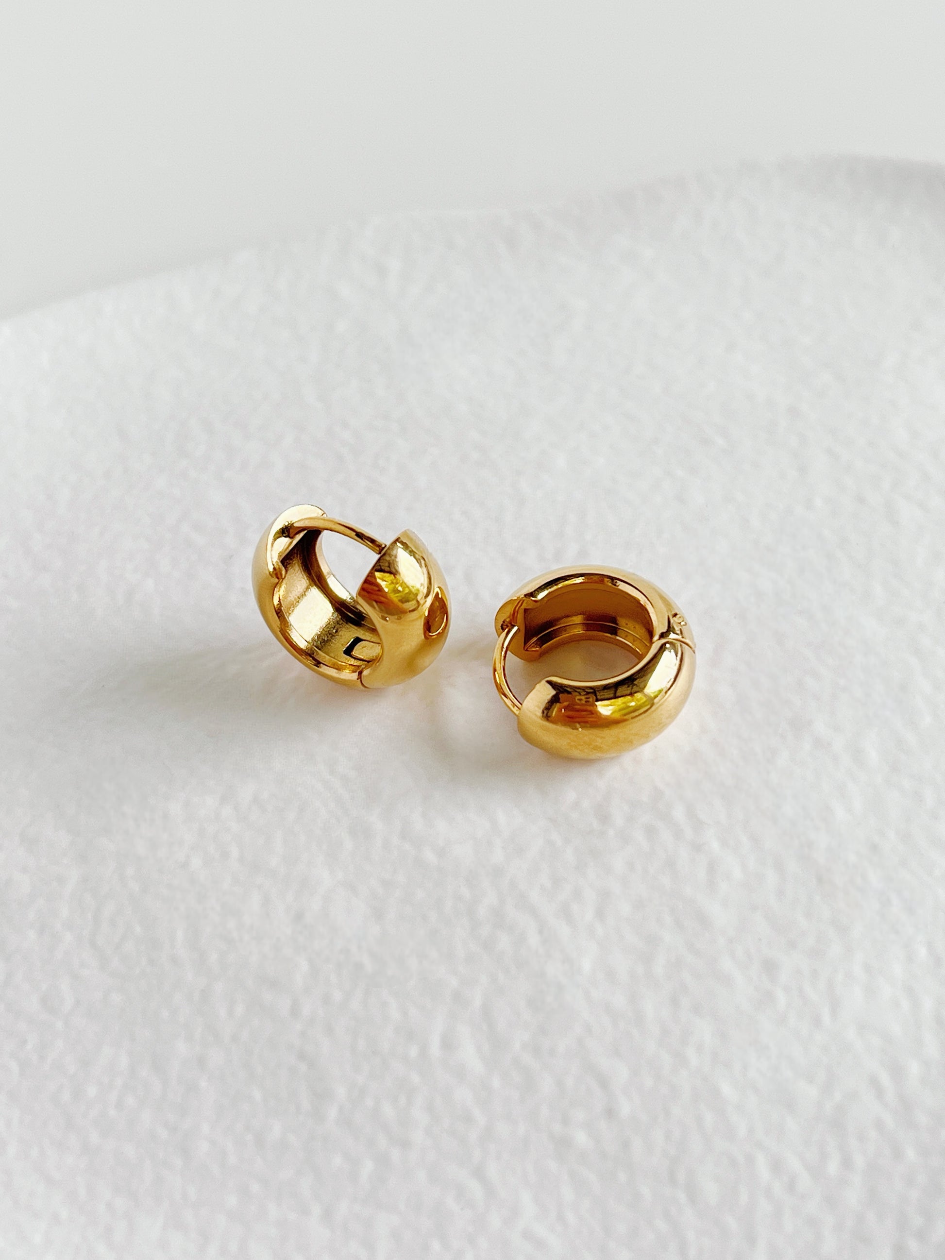 Close-up of Amie Gold Chunky Hoops showing high-polish finish.