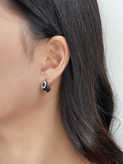 Close up of model's ear showing Amie silver hoops.