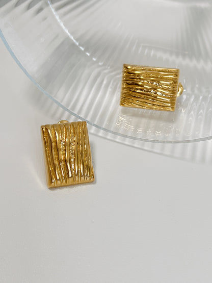 Gold rectangular earrings with unique vertical texture.