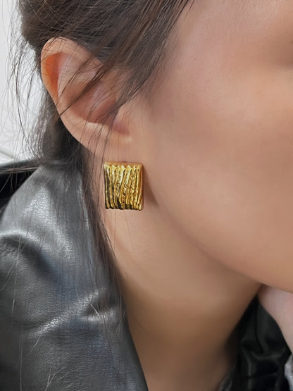 Stylish gold rectangle earrings with a vertical pattern.