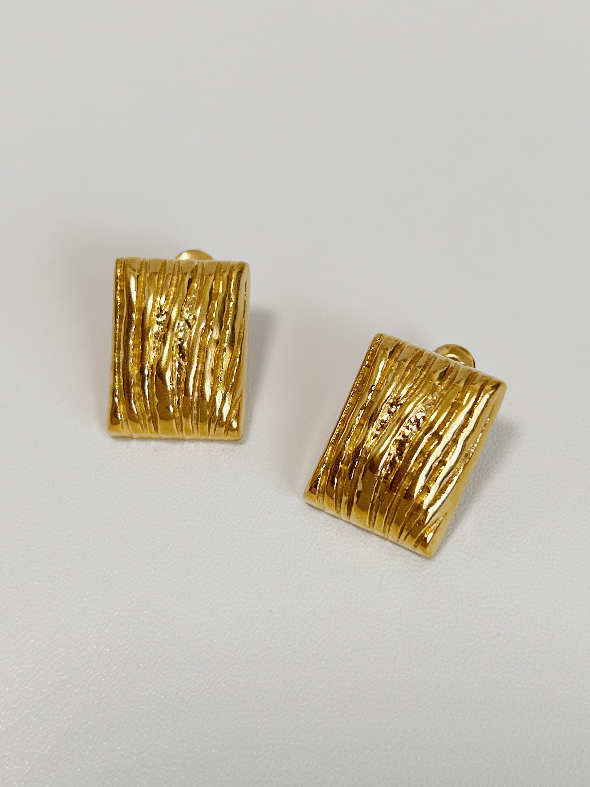 Elegant gold rectangular earrings with a distinctive texture design