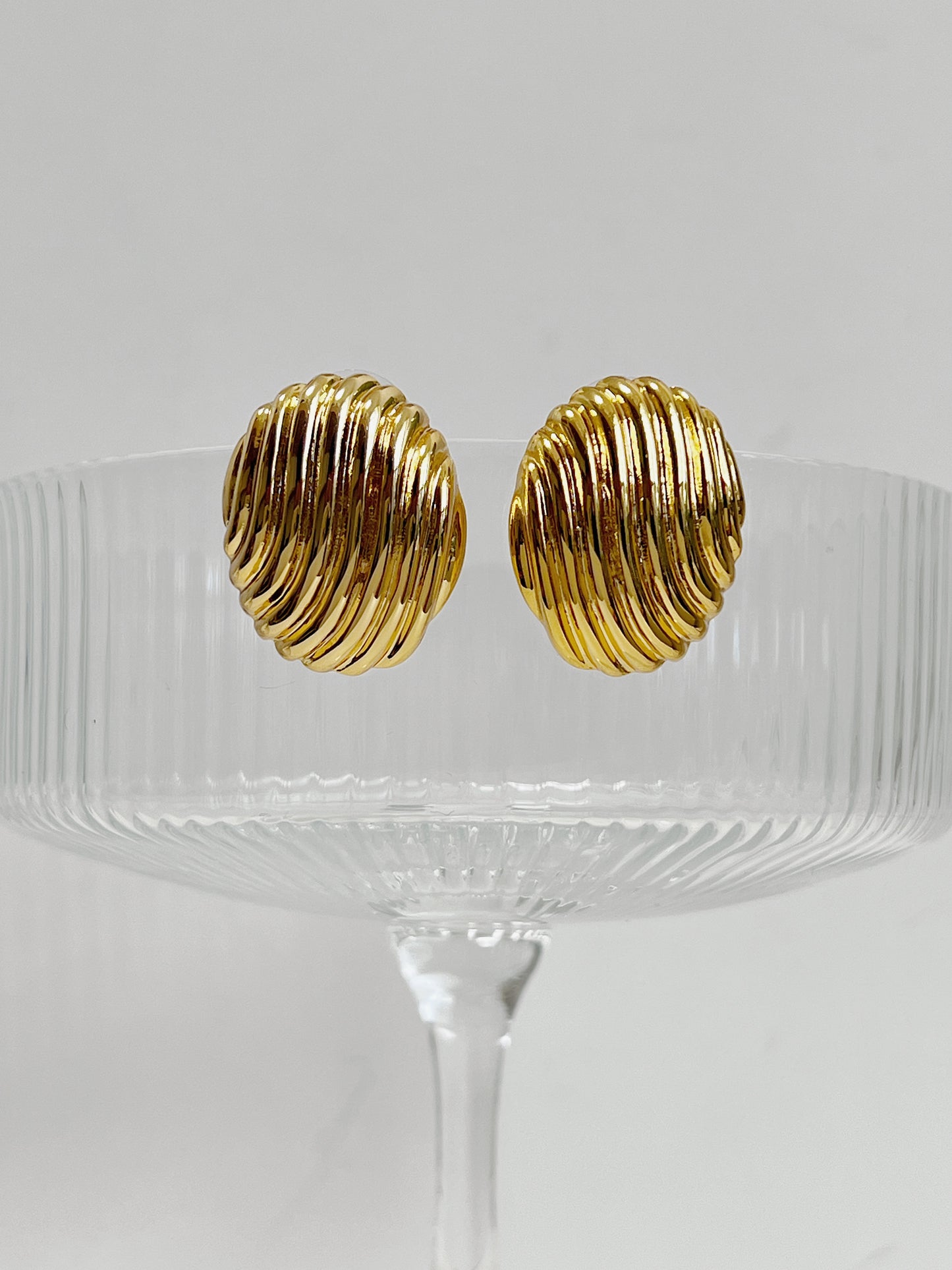 Luxurious gold ribbed oval earrings for women.