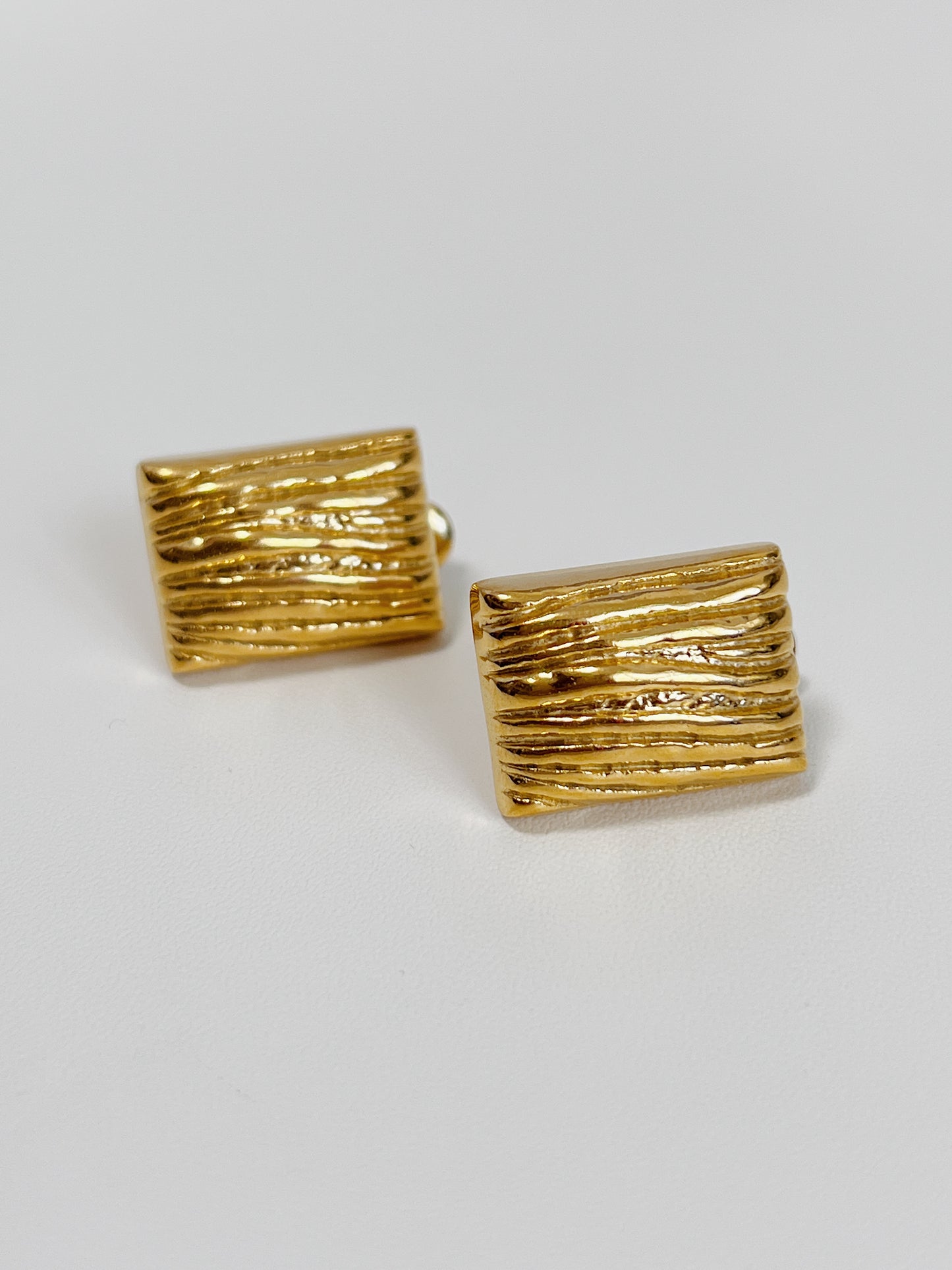 Textured gold rectangle earrings for a chic look.