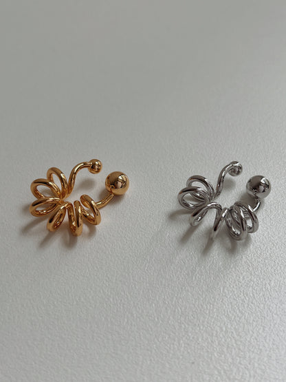 Gold and silver Lis cuffs side-by-side to highlight the liquid-mirror finish.