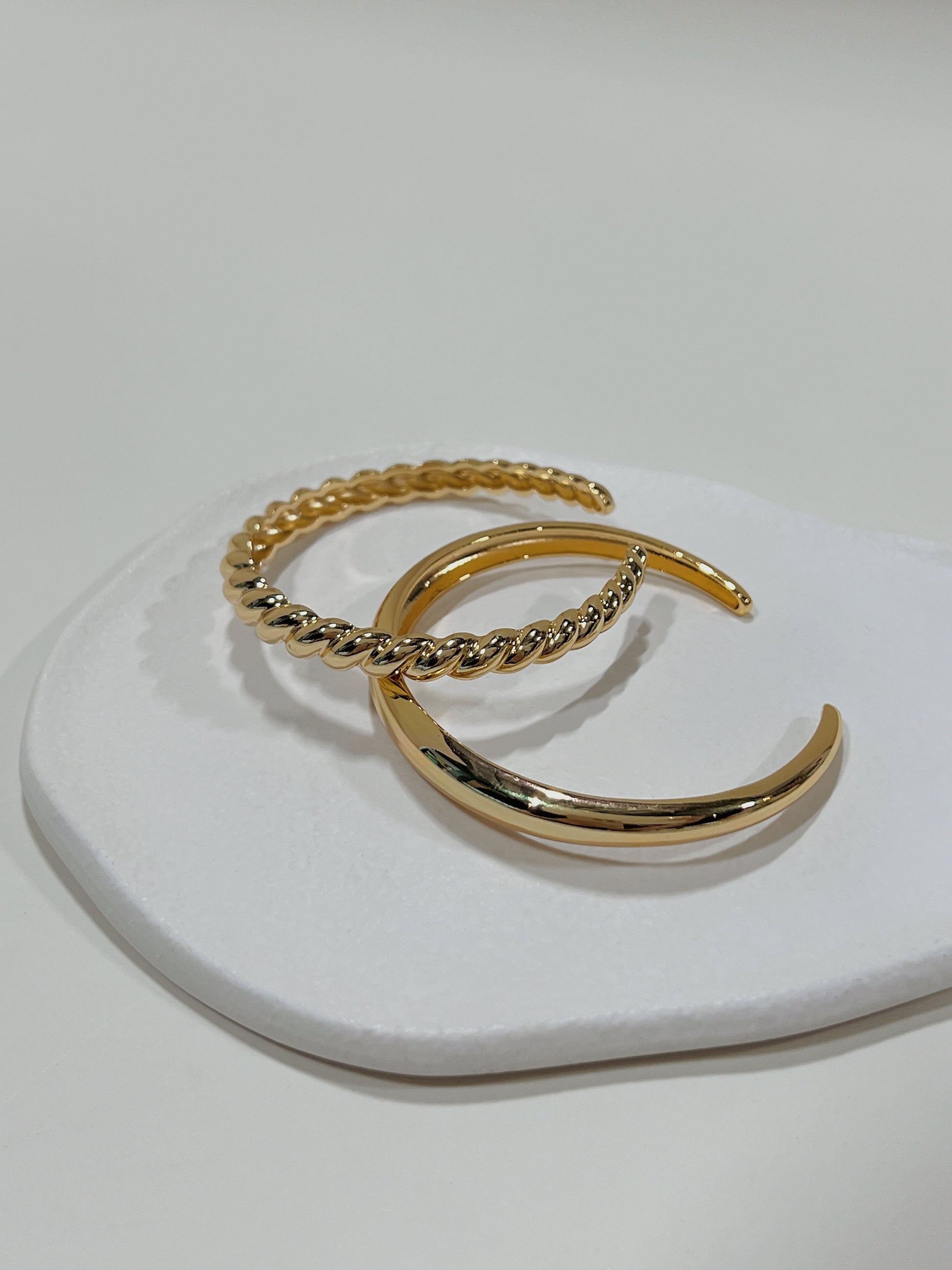 Close-up of the smooth inner bands and slightly adjustable open-gap frame of our premium gold plated cuff bangles.