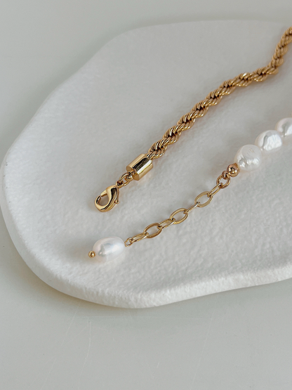 Back detail of jewelry extender chain and lobster clasp with tiny baroque pearl accent