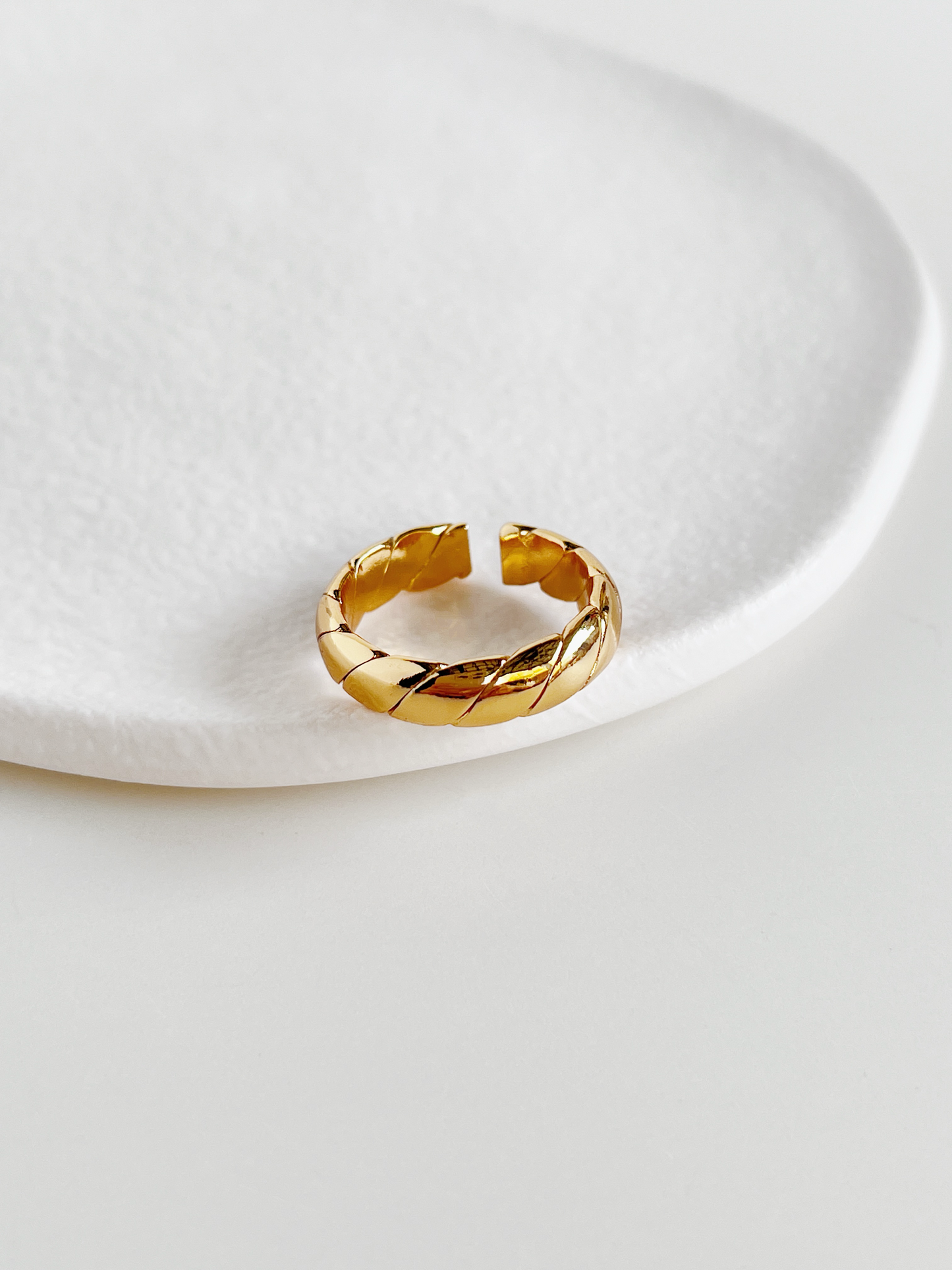 Adjustable open back gold ring showing smooth interior comfort fit construction