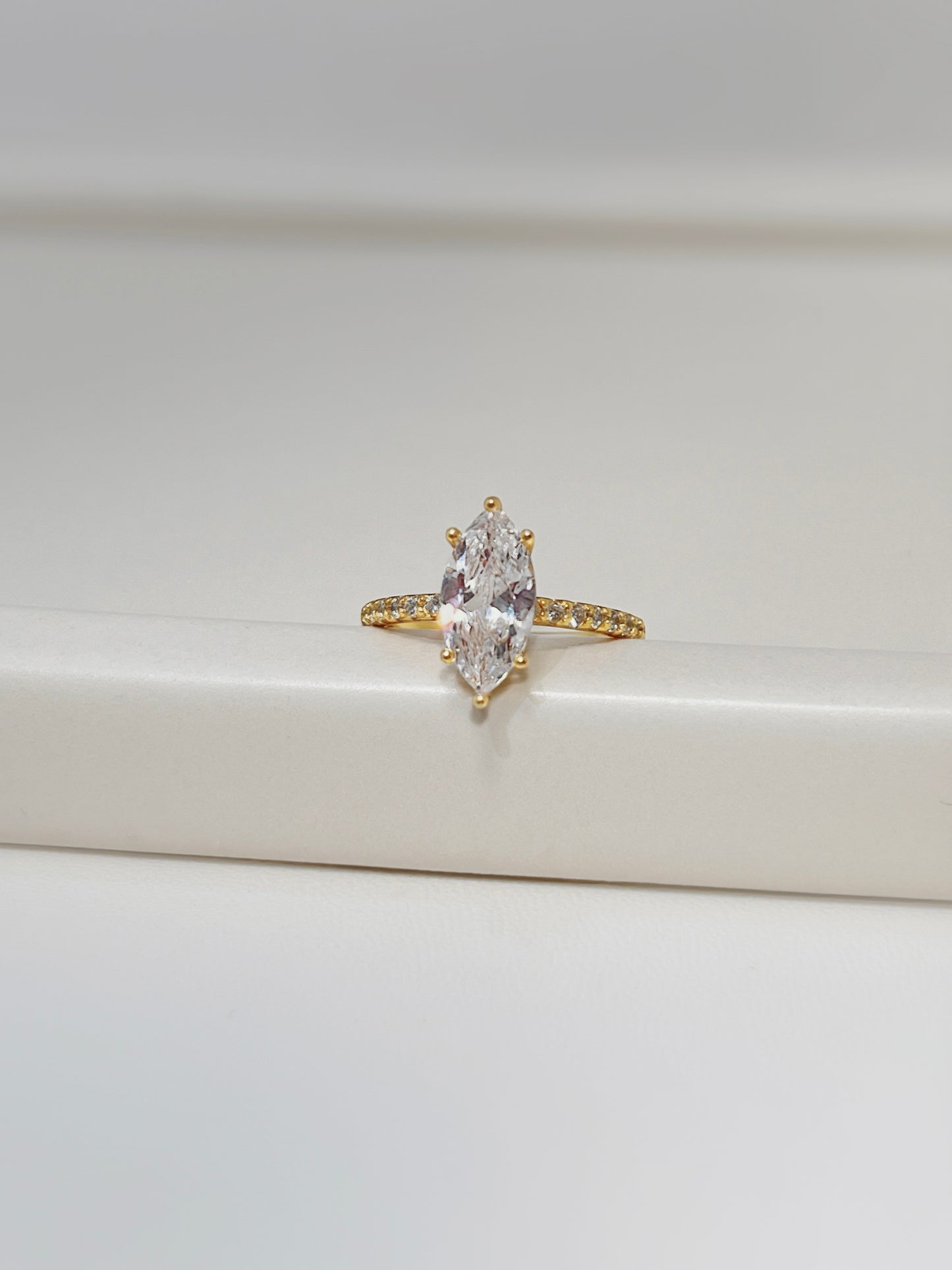 Close-up of 7 pavé stones on a gold vermeil ring band detail.