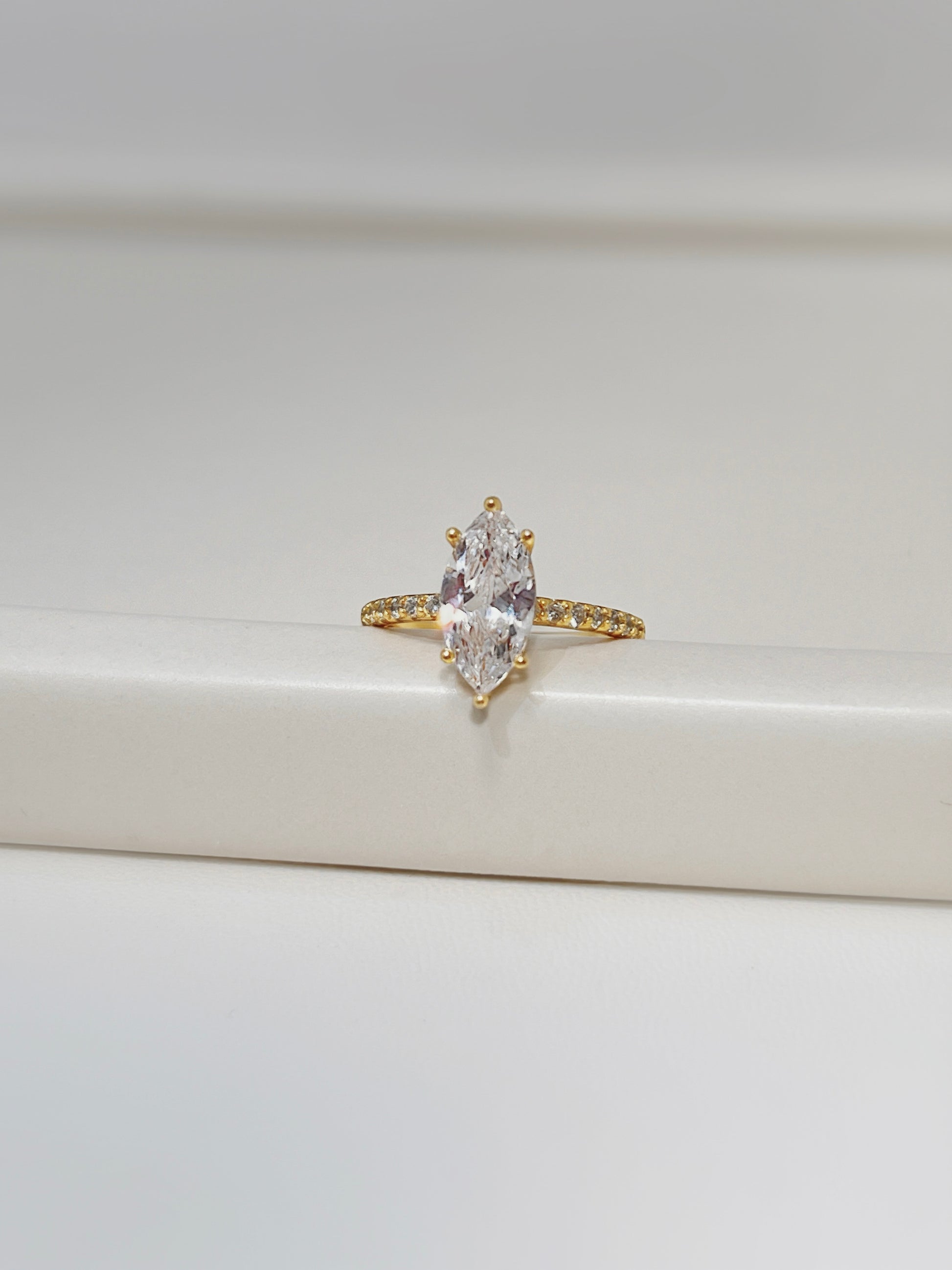 Close-up of 7 pavé stones on a gold vermeil ring band detail.
