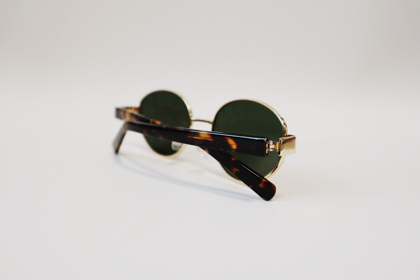 Inside macro view of the Amalfi eyewear, focusing on the tortoiseshell acetate side arms.