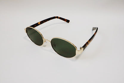 Creative studio shot of the Amalfi frames, capturing the rich forest-tinted lens shadows cast on a textured background.