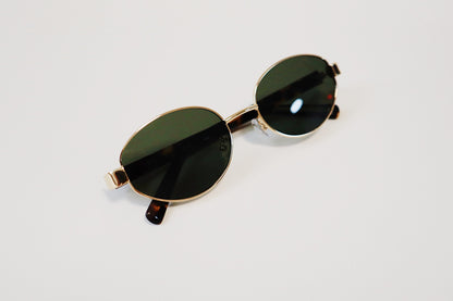 Close-up studio detail of the Amalfi frames, highlighting the rich, uniform opacity of the solid bottle-green lenses under direct lighting.