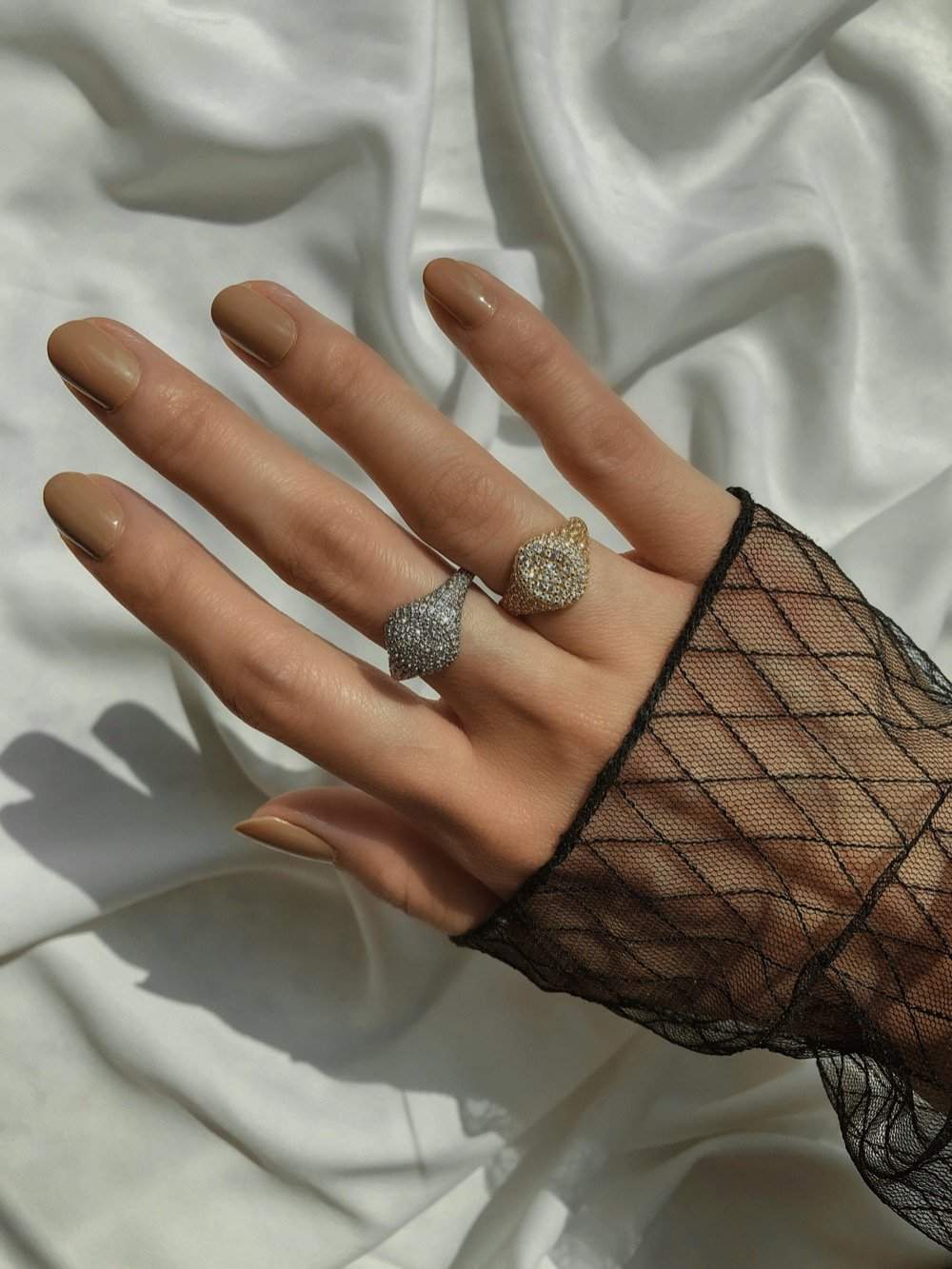 Model gesturing with a lightweight 18k gold vermeil statement ring.
