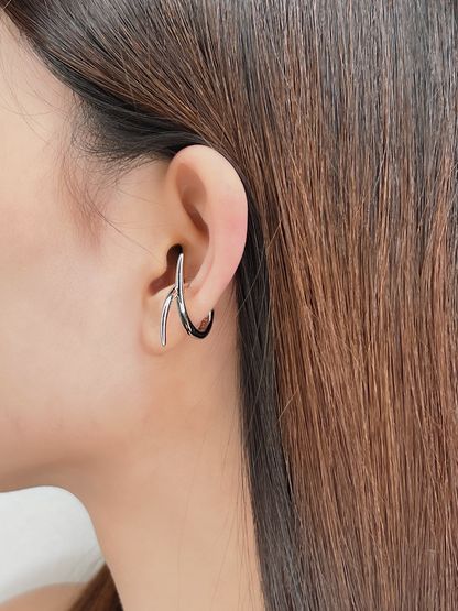 Profile view of model wearing the Harley cuff to show how the "X" shape contours the ear.
