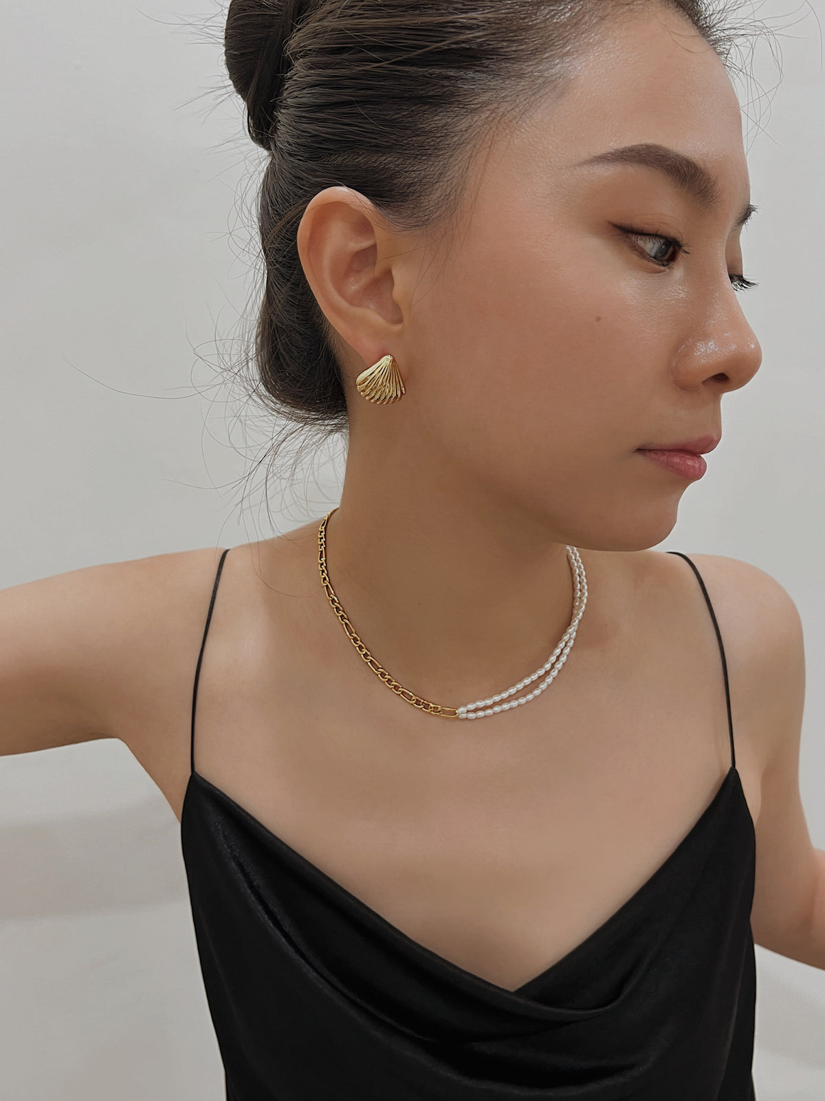 Side profile shot showing comfortable fit of Ariel spiral clip-on shell stud on unpierced earlobe