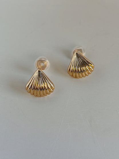 Macro view of scalloped fluted grooves on 18K gold plated Ariel shell clip-on stud earring
