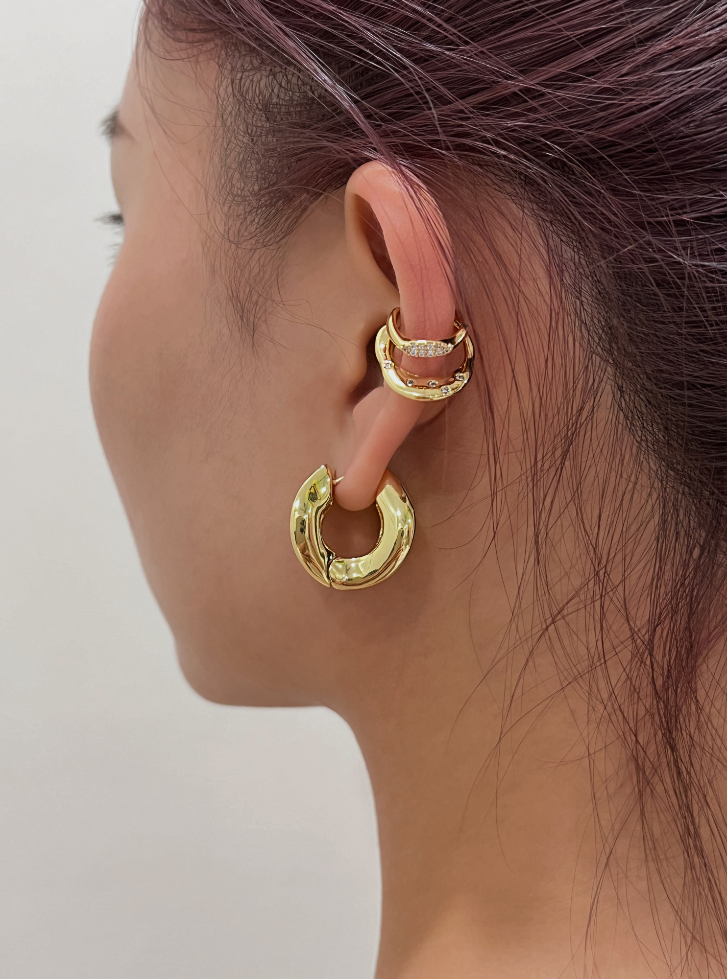 Model wearing Ashley Double Band Gold Cuff at the mid-ear.