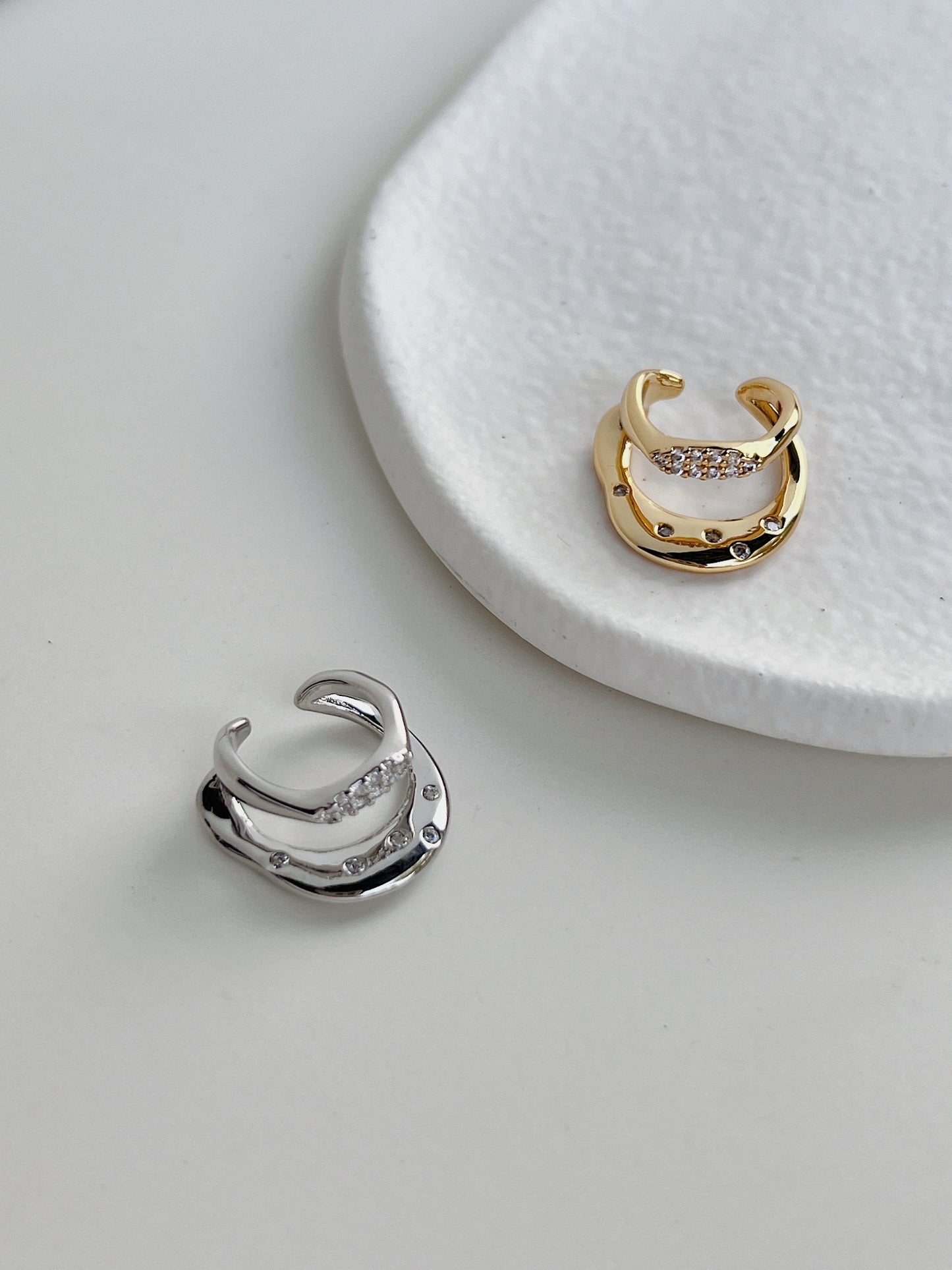 Ashley CZ Double Band Ear Cuff in 18K Gold PVD and Rhodium PVD on white background.