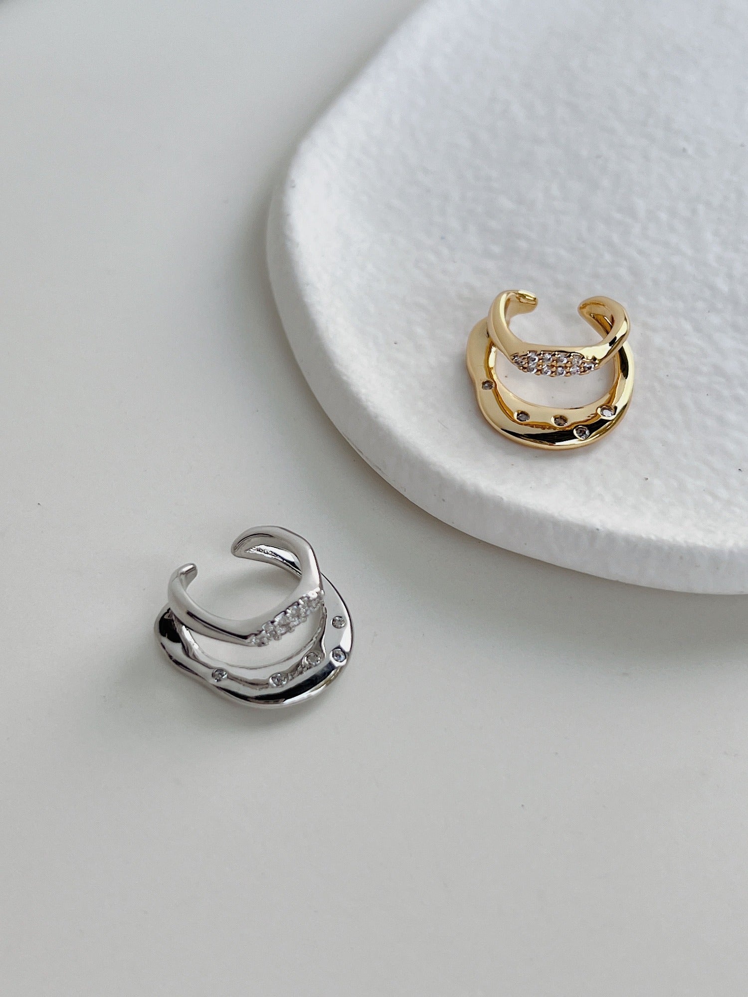 Ashley CZ Double Band Ear Cuff in 18K Gold PVD and Rhodium PVD on white background.