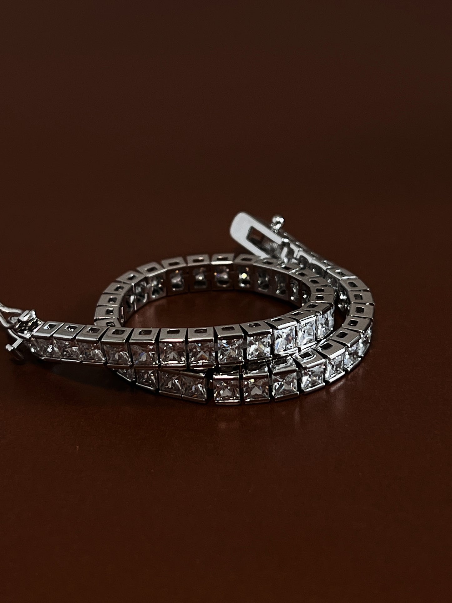 Macro perspective detailing the open box clasp mechanism and double side safety catches on a rhodium channel-set cubic zirconia bracelet, engineered for snag-free daily wear in modern jewellery collections.