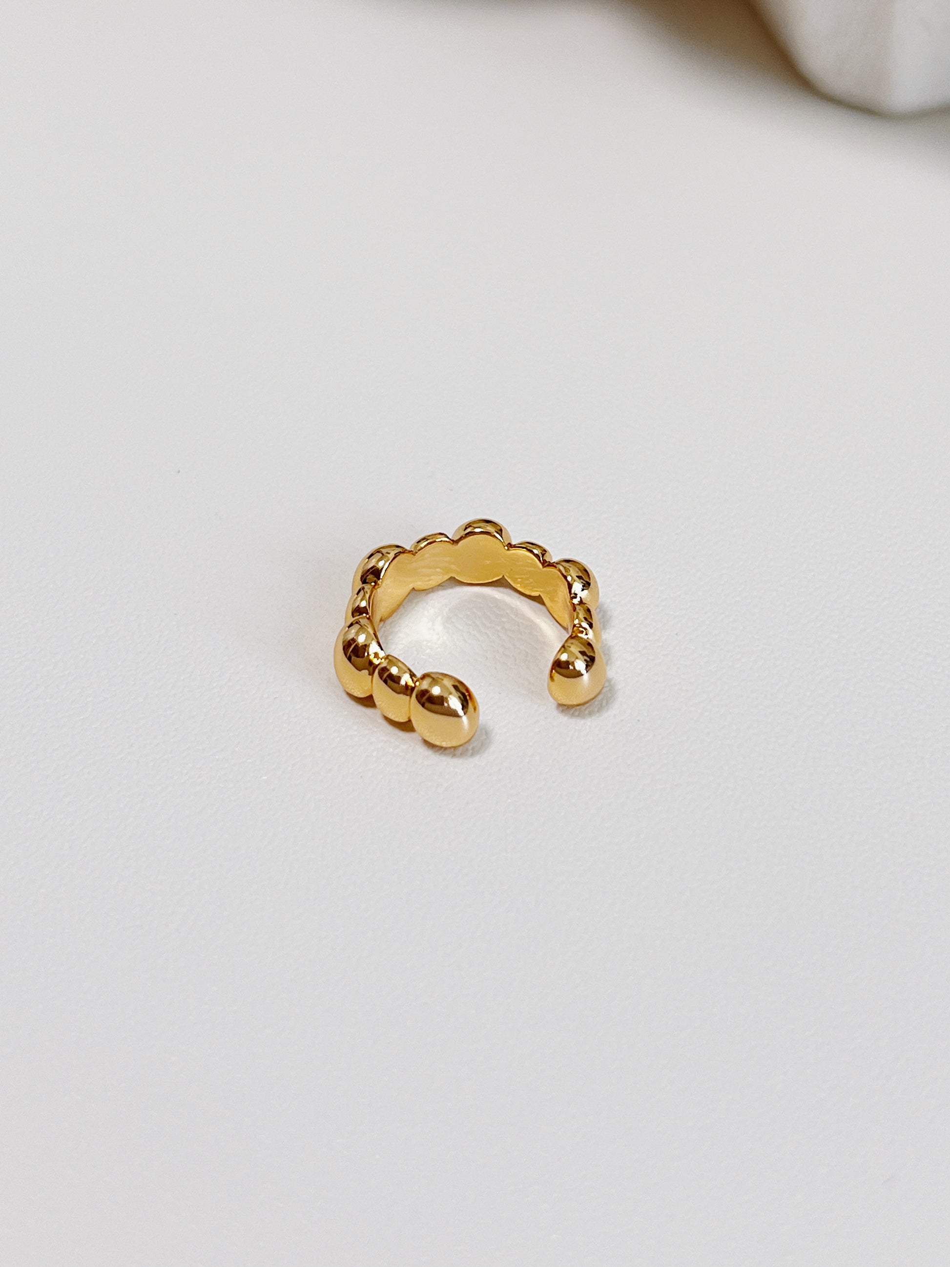 Detailed view of the PVD gold finish on the interior of the Carina brass ear cuff.