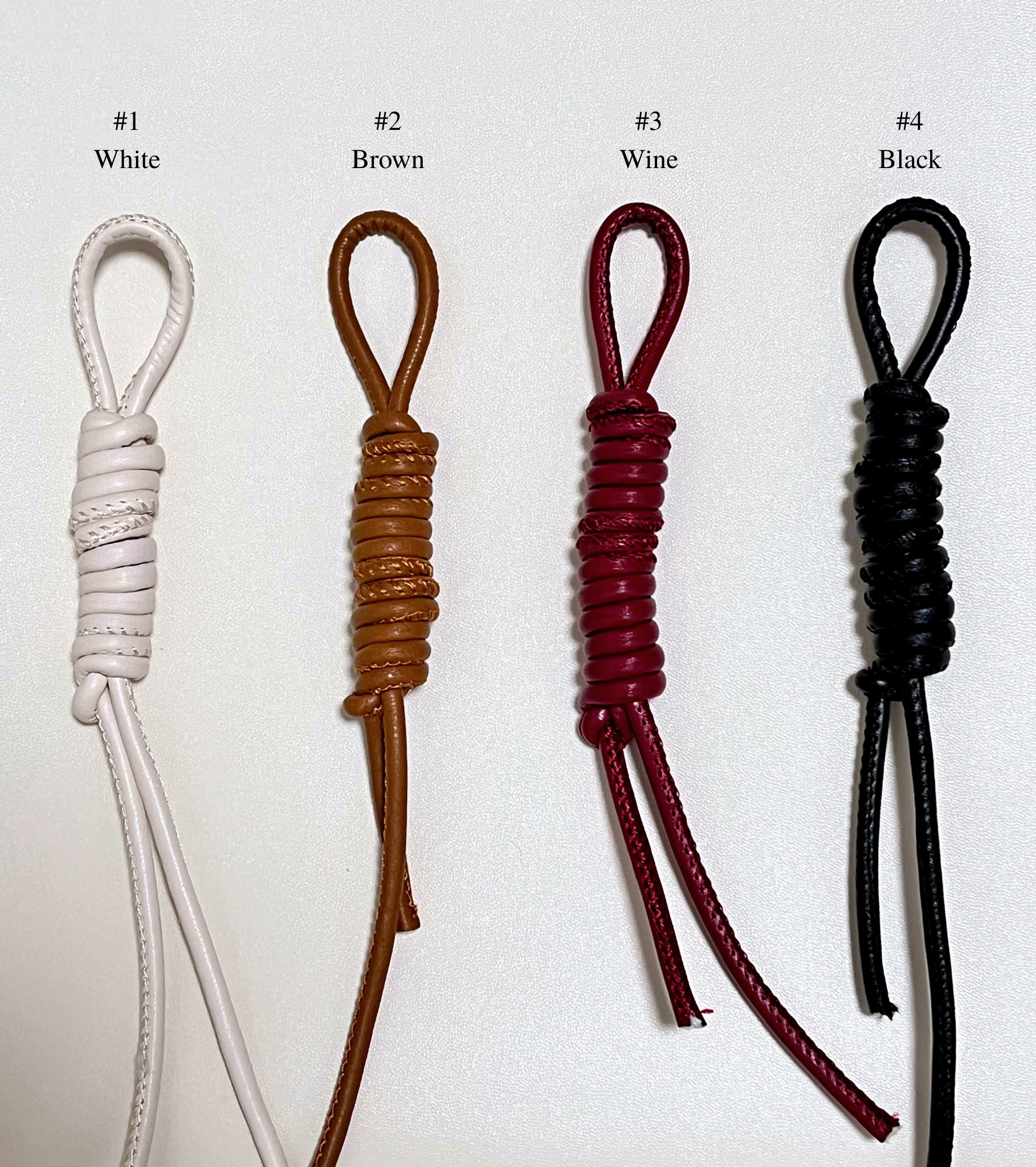 Four leather straps in different colors for personalized option.