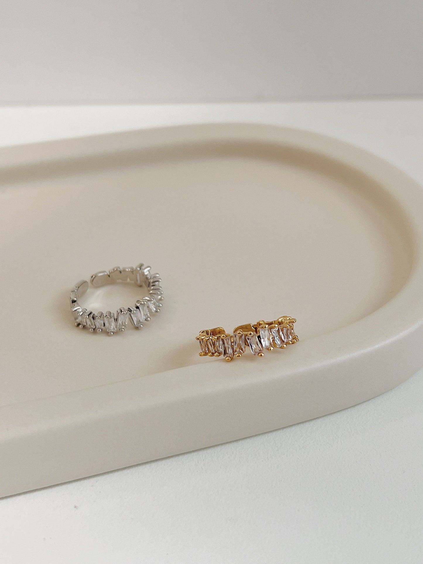 Polished gold and silver-tone baguette eternity band with rhythmic crystal arrangement