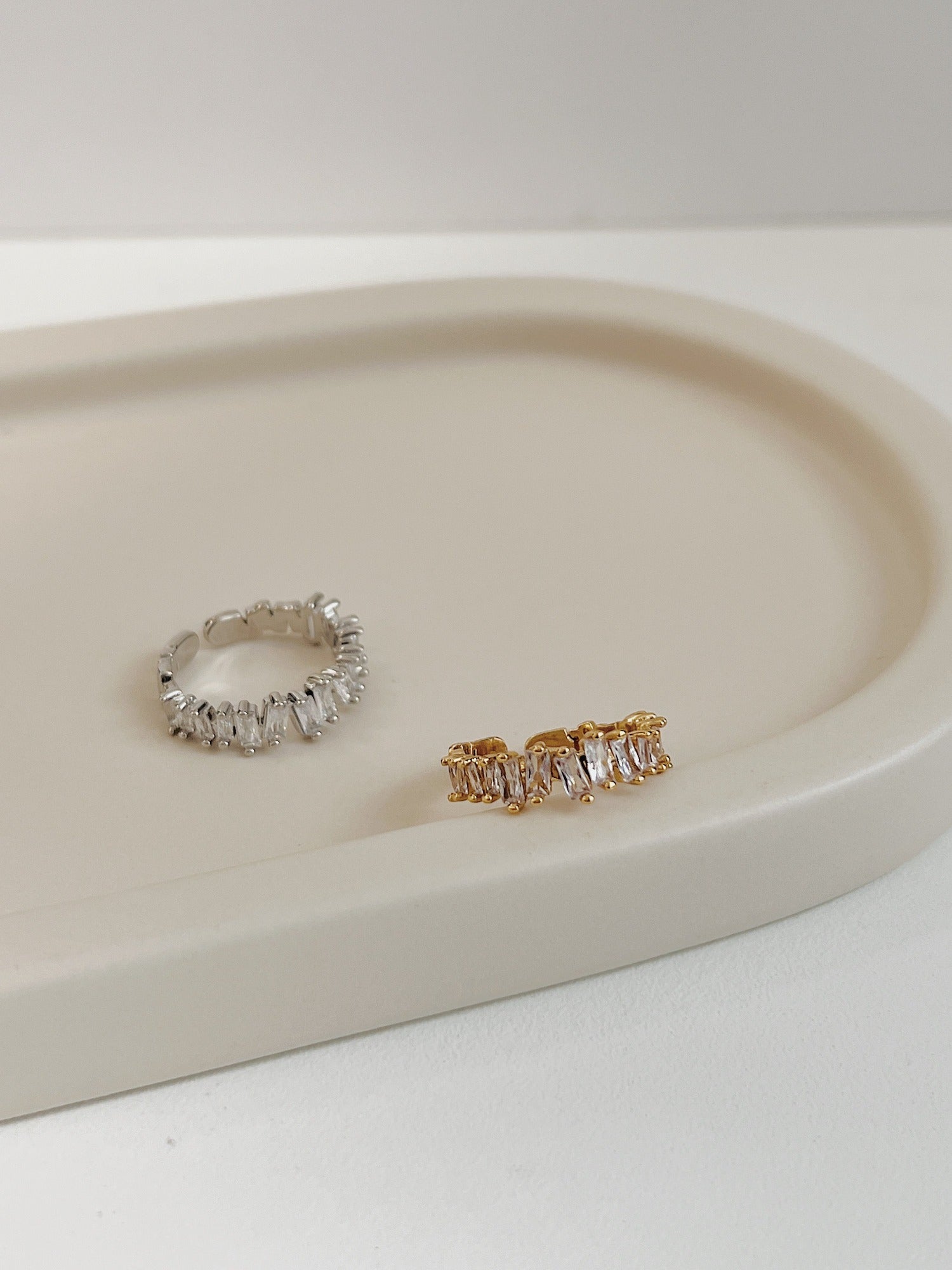 Polished gold and silver-tone baguette eternity band with rhythmic crystal arrangement