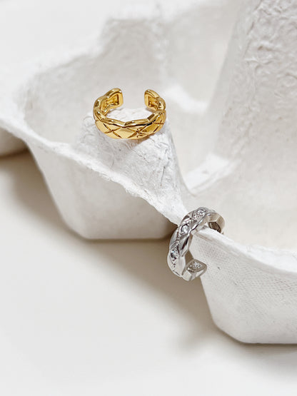 Pair of Louie ear cuffs in gold and silver showing high-mirror finish.