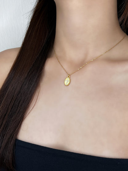 A studio presentation of the Gianna cross necklace styled on a female model to highlight its luxury and minimal aesthetic