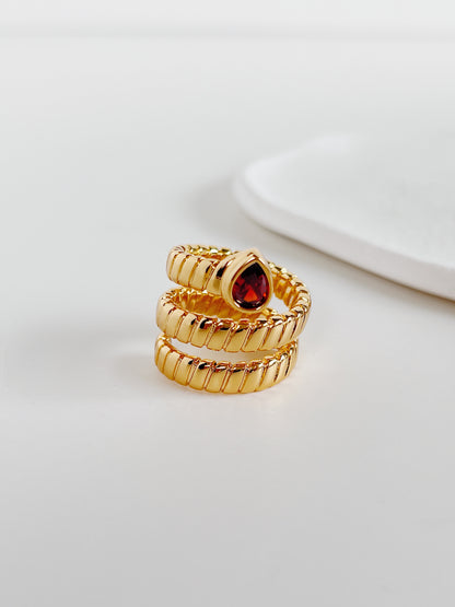 Soft mirror shine ruby like gemstone ring by Aurous Atelier on white surface