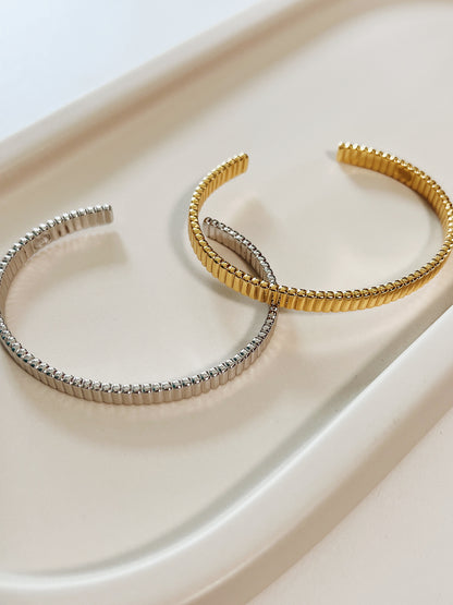 Complete studio layout of the Vede gold and silver texturized cuffs emphasizing their premium finish and uniform architectural grooves.