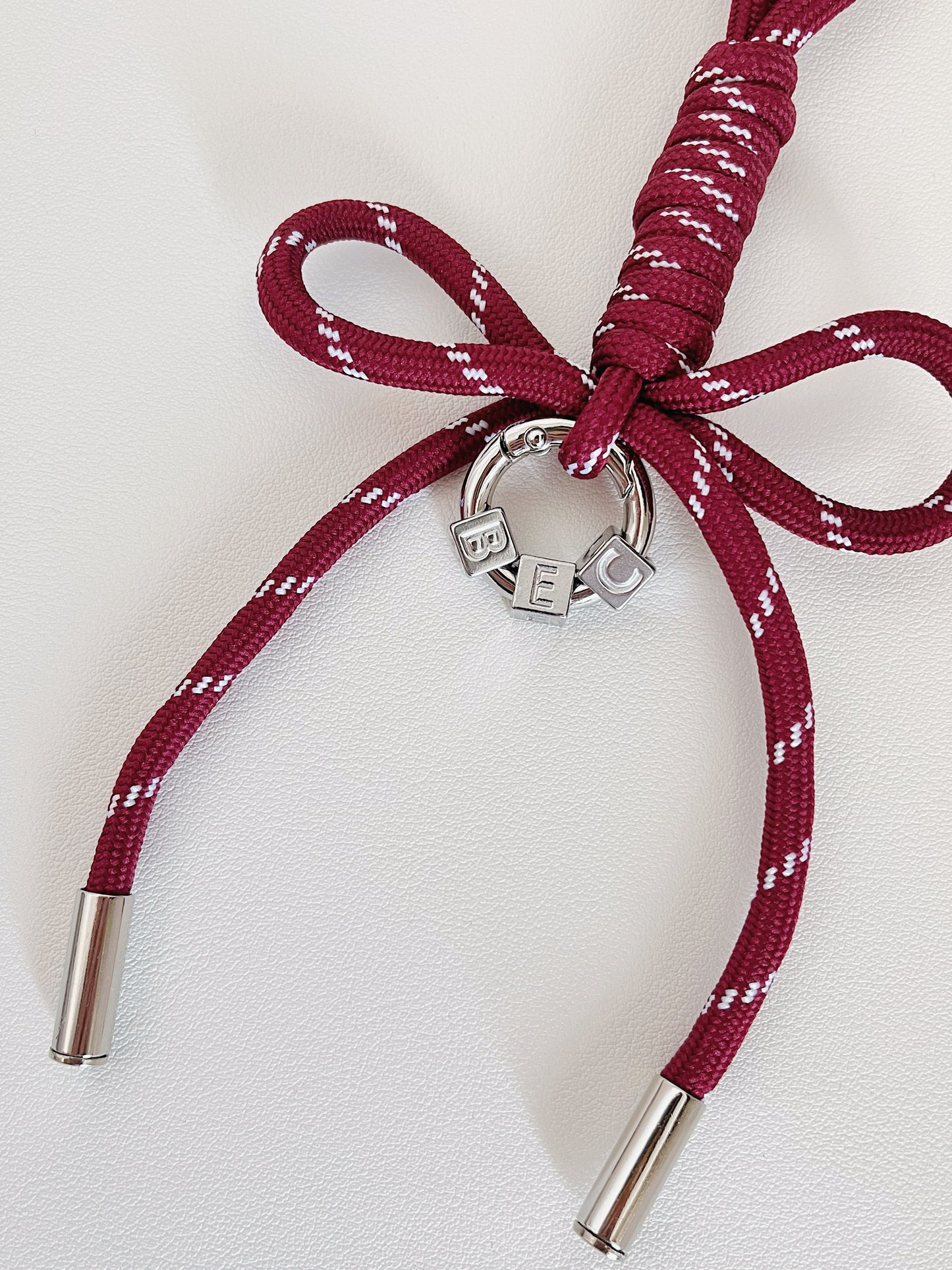 Luxury bag customization layout presenting an array of colorful personalized initial ribbon charms