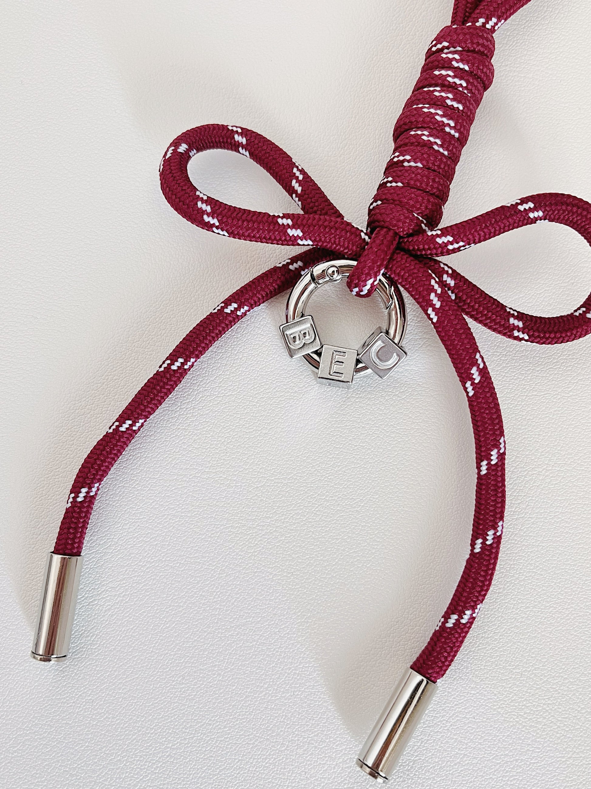 Luxury bag customization layout presenting an array of colorful personalized initial ribbon charms