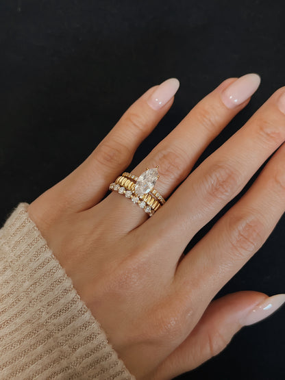 Aurous Atelier fine jewelry lookbook presentation displaying a curated multi-textured gold vermeil ring stack on a hand with neutral manicured nails