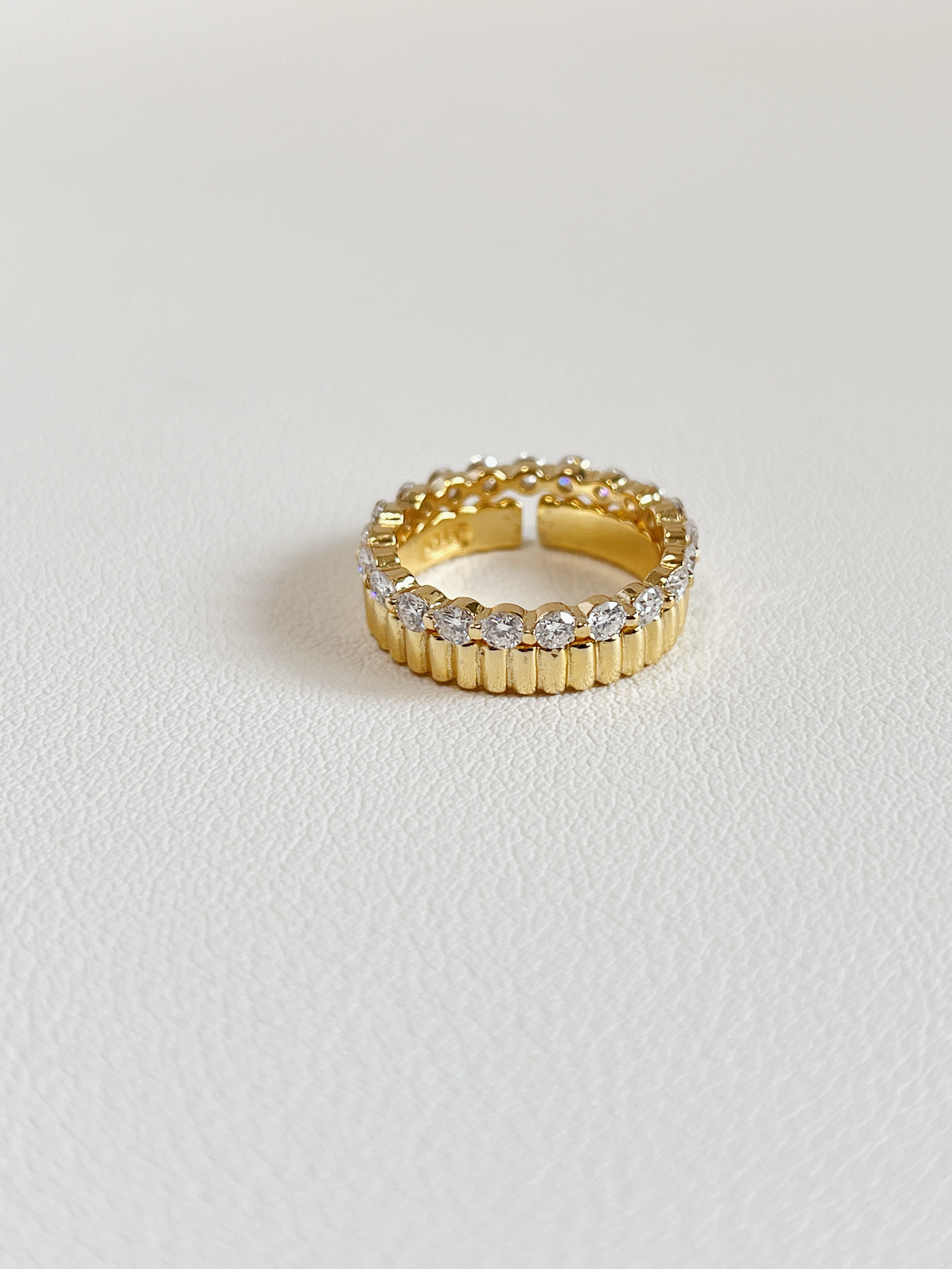 Aurous atelier fine jewelry showcase highlighting a full eternity sparkling band stacked with architectural gold