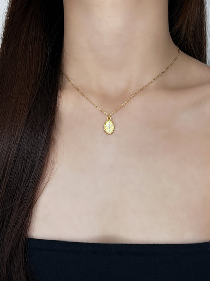 Front lookbook framing of a model wearing the brilliant 5A cubic zirconia stone cross pendant against a bare collarbone