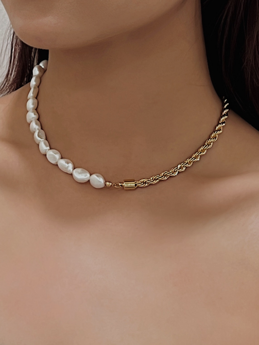 Model collarbone view wearing an asymmetrical genuine freshwater pearl and gold chain necklace
