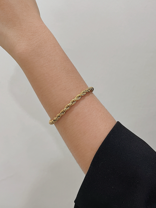 A clean arm profile view demonstrating how the 5mm gold rope chain drapes comfortably against skin.