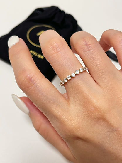 Overhead view of the Callie delicate gold eternity ring with round moissanite