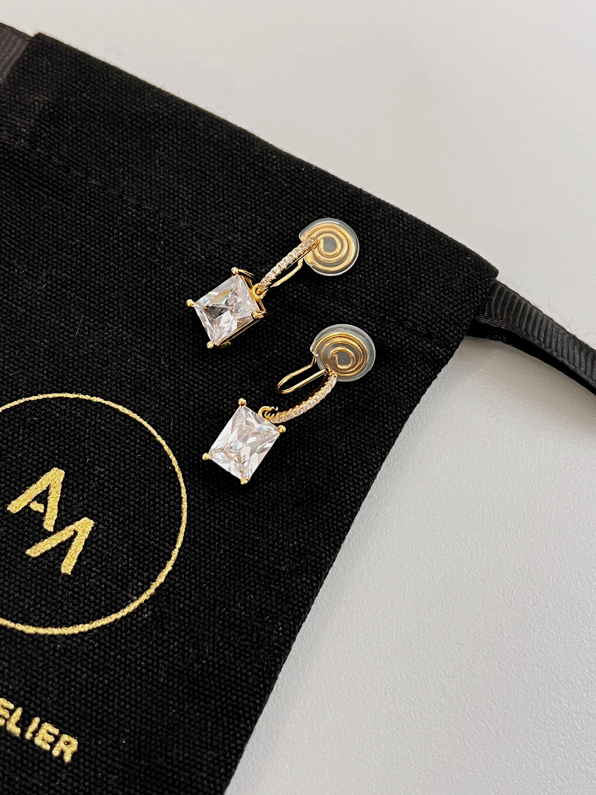Side profile of Candice clip-on drop earring highlighting thin wire clip structure and drop ring attachment