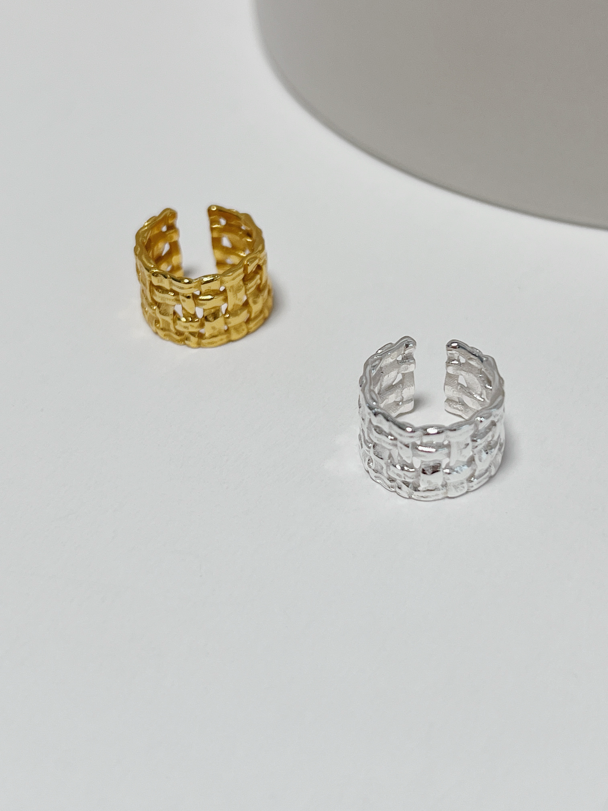 Close-up of gold Carmela Woven Ear Cuff showing the S925 hallmark and intricate basket-weave texture.