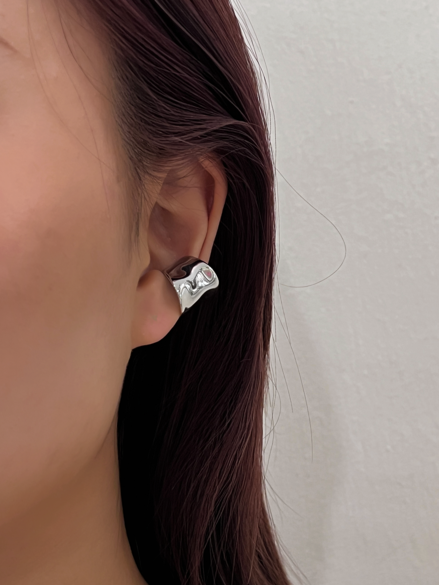 Model showcasing Kelly wide cuff with minimalist slicked-back hair.
