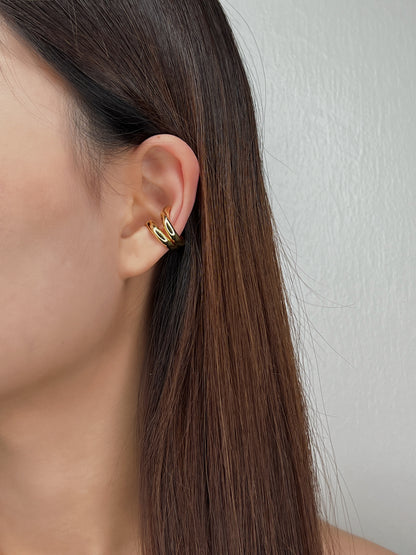 Model styling Tobi cuffs with slicked-back hair.