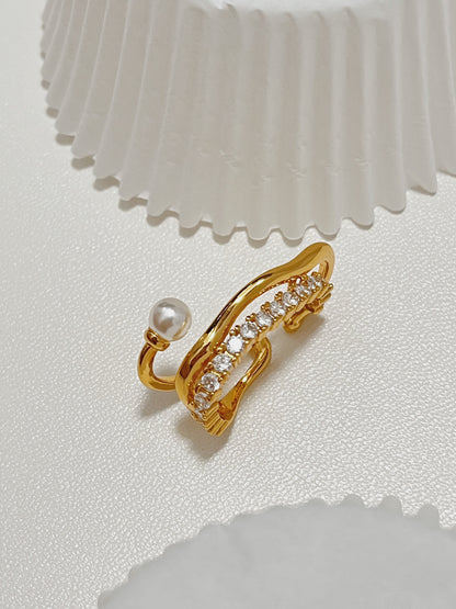 Elevated profile perspective of the multi-strand Cassidy Pearl and Pave Crystal Gold Ear Lobe Cuff Earrings, highlighting its unique wrapped wire form and brilliant sparkle.