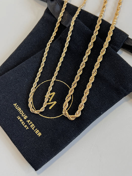 Chelsea gold twisted rope chain necklace resting beautifully on aurous atelier jewelry pouch