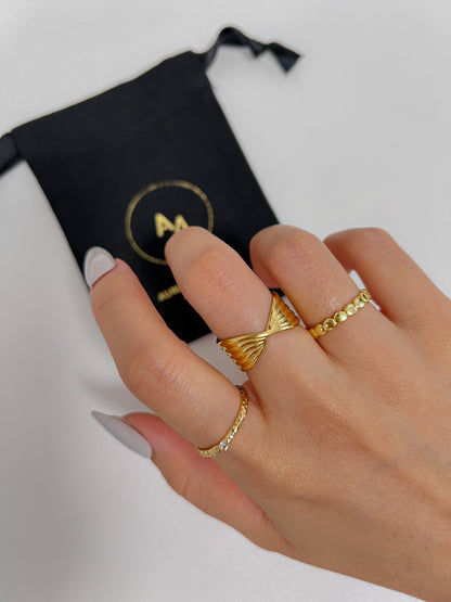 Editorial photo of a model hand styling architectural gold tarnish resistant jewellery